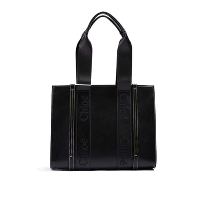 Alt Tag: Chloé Black Woody Embroidered Logo Leather Medium Tote Bag with black leather, medium size, embroidered logo, and sturdy handles.