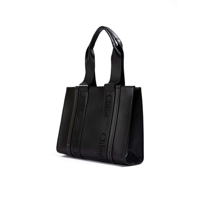 Chloé Black Woody Embroidered Logo Leather Medium Tote Bag with embroidered logo, black leather material, medium size, and sturdy handles.