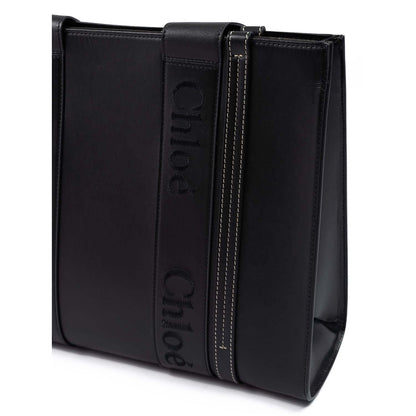 Chloé Black Woody Embroidered Logo Leather Medium Tote Bag with detail of embroidered logo on black leather