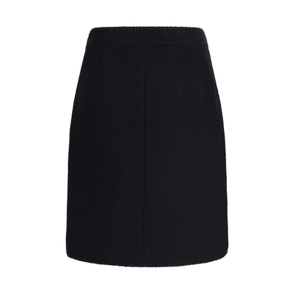 Chloé Black Wool Midi Skirt with bouclé texture, front flap pockets, and gold-tone button accents, designed for an elegant, structured silhouette.