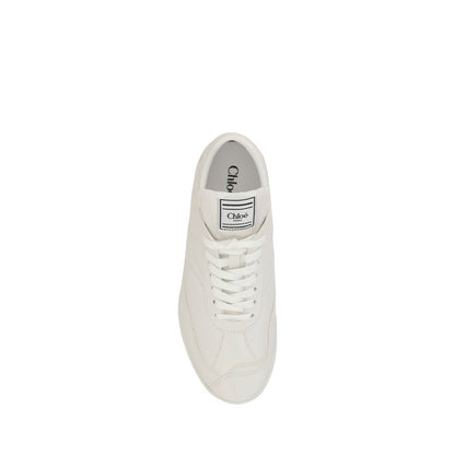 Chloé White Calf Leather Bos Taurus Low Top Sneakers with flat sole, front lace-up closure, and logo patch for a stylish, dynamic look.