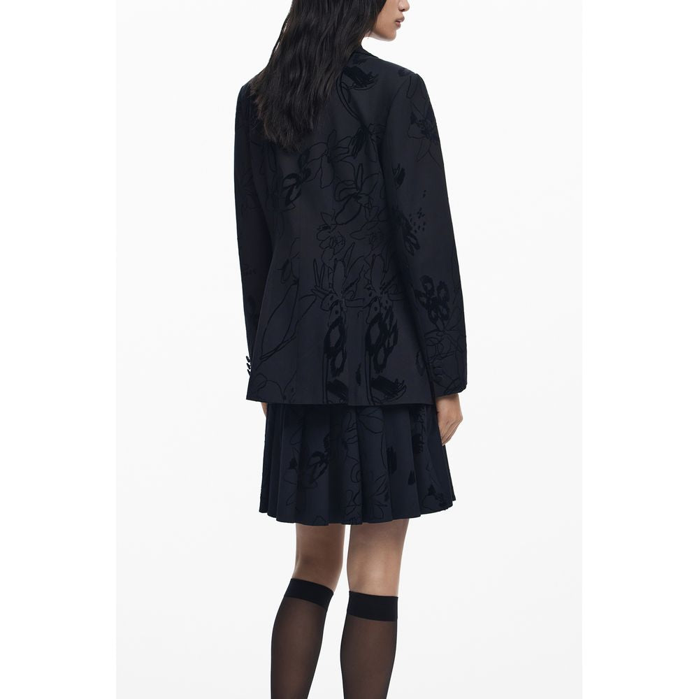 Woman wearing Desigual Black Polyester Women Jacket with floral pattern, featuring V-neck, sleek pockets, and stylish buttons.