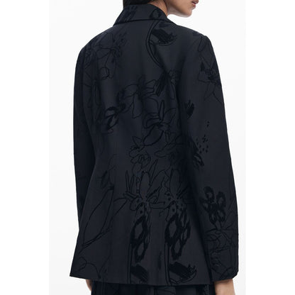 Woman wearing Desigual Black Polyester Women Jacket with floral patterns and V-neck, showcasing trendy style and comfort.