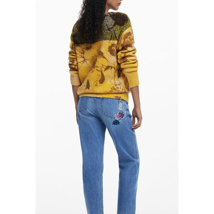 Back view of Desigual Yellow Wool Women Sweater with floral design, paired with embroidered jeans, showcasing modern fashion and style.