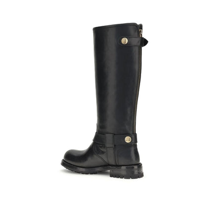Side view of Dolce & Gabbana Black Calf Leather Bos Taurus Lace-Up Boots with buckle detailing and rugged sole.