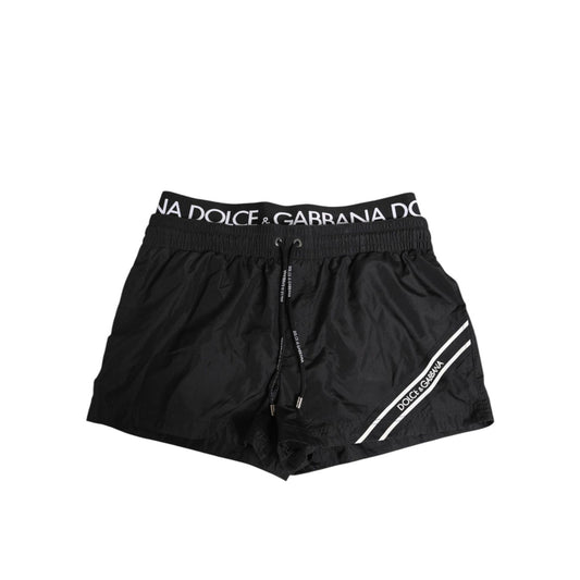 Dolce & Gabbana Black Drawstring Beachwear Men Shorts Swimwear with logo elastic waistband and side pocket detail.