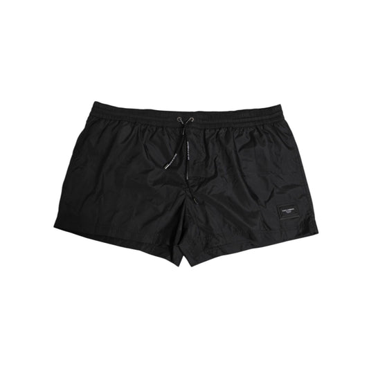Dolce & Gabbana Black Logo Polyester Beachwear Shorts Swimwear with iconic logo detail, elastic waistband, and quick-dry comfort.