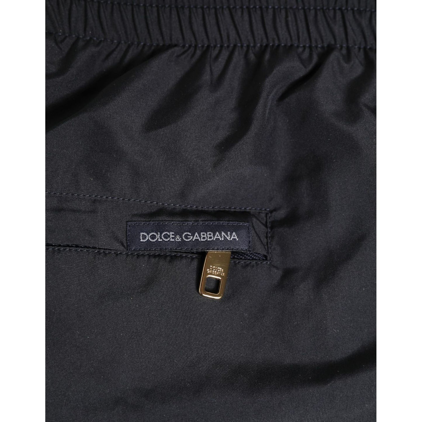 Close-up of Dolce & Gabbana Black Nylon Side Logo Tape Shorts Swimwear with zipper detailing.