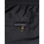 Close-up of Dolce & Gabbana Black Nylon Side Logo Tape Shorts Swimwear with zipper detailing.