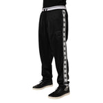 Dolce & Gabbana Black Polyester Logo Stripe Track Jogger Pants with drawstring waist and DG logo, perfect for casual athleisure style.