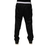 Back view of Dolce & Gabbana Black Polyester Logo Stripe Track Jogger Pants with white waistband and sporty fit.