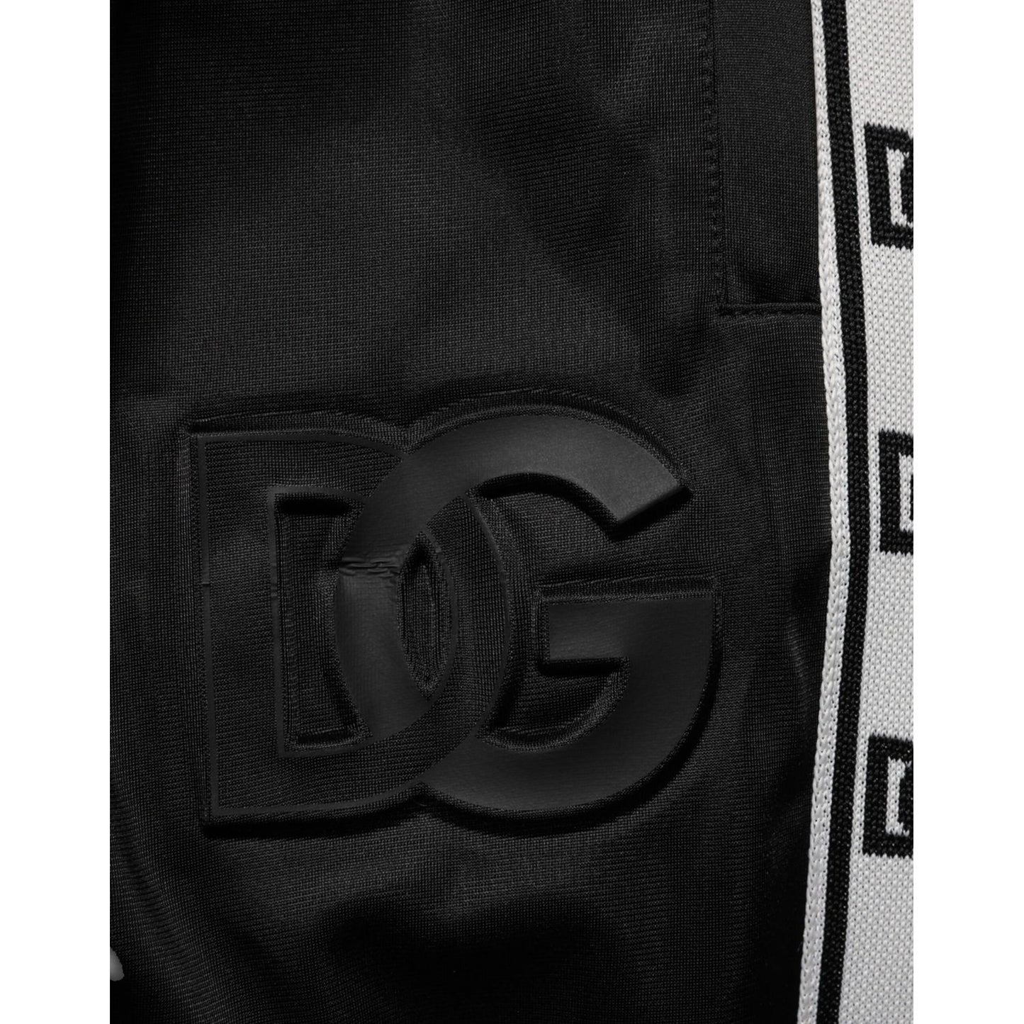 Close-up of Dolce & Gabbana Black Polyester Logo Stripe Track Jogger Pants showcasing DG logo and stripe detail.