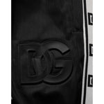 Close-up of Dolce & Gabbana Black Polyester Logo Stripe Track Jogger Pants showcasing DG logo and stripe detail.