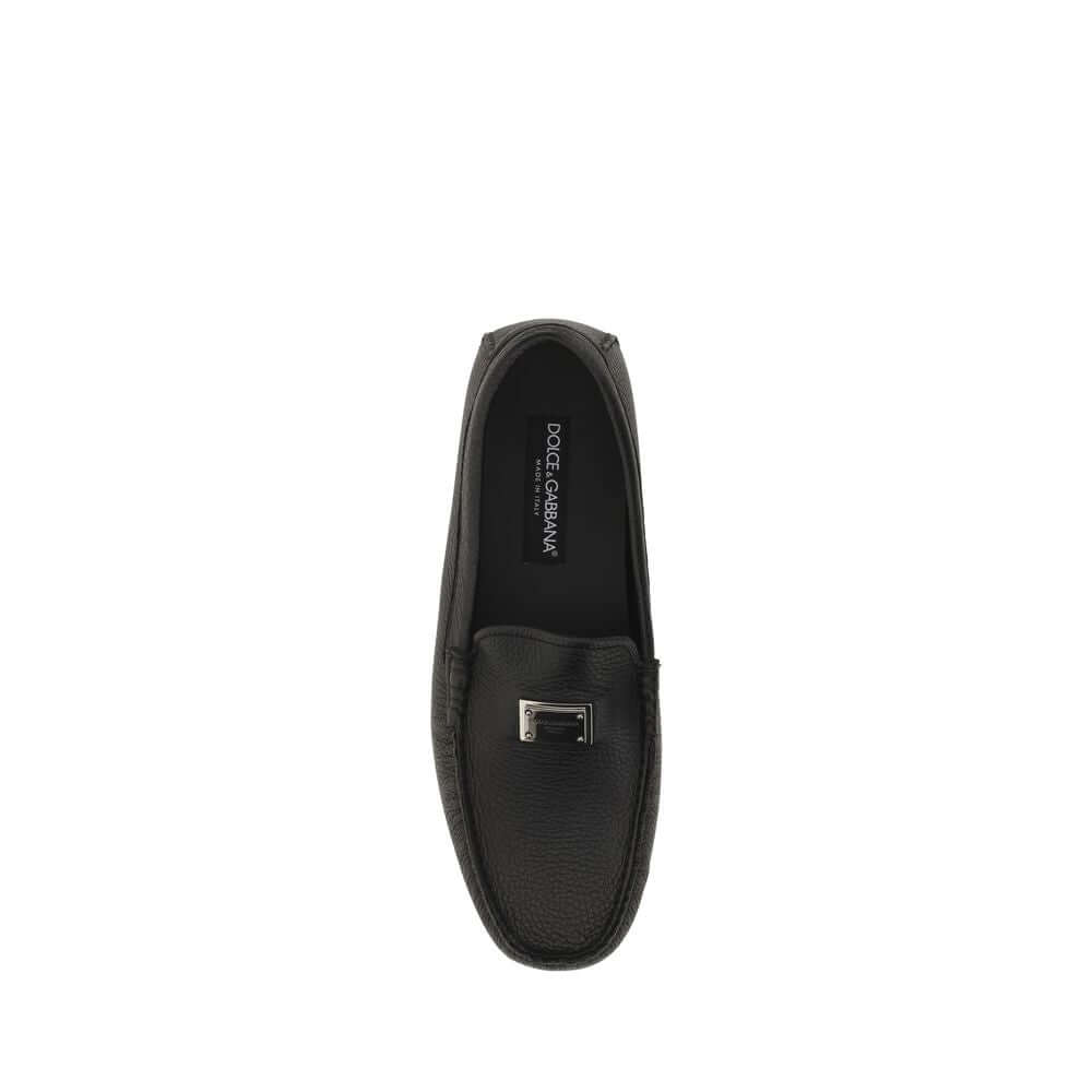 Top view of Dolce & Gabbana Black Rubber Slip-On Loafers with metal monogram plaque, calfskin upper and non-slip sole.