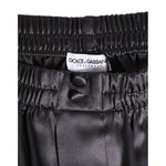 Dolce & Gabbana Black Satin Silk Elastic Men Boxer Short Swimwear waistband close-up with logo and button details.
