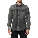 Man wearing Dolce & Gabbana Black Washed Cotton Snap Long Sleeve Casual Shirt with distressed finish and chest flap pockets.