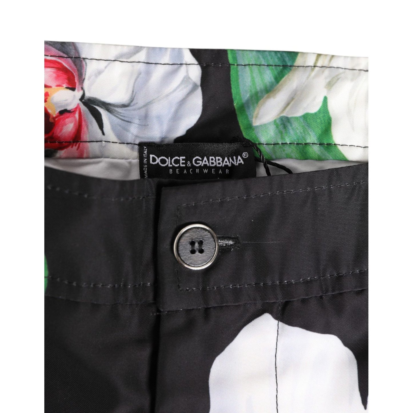 Close-up of Dolce & Gabbana Black White Polyester Floral Orchid Print Shorts featuring waistband detail and floral design.