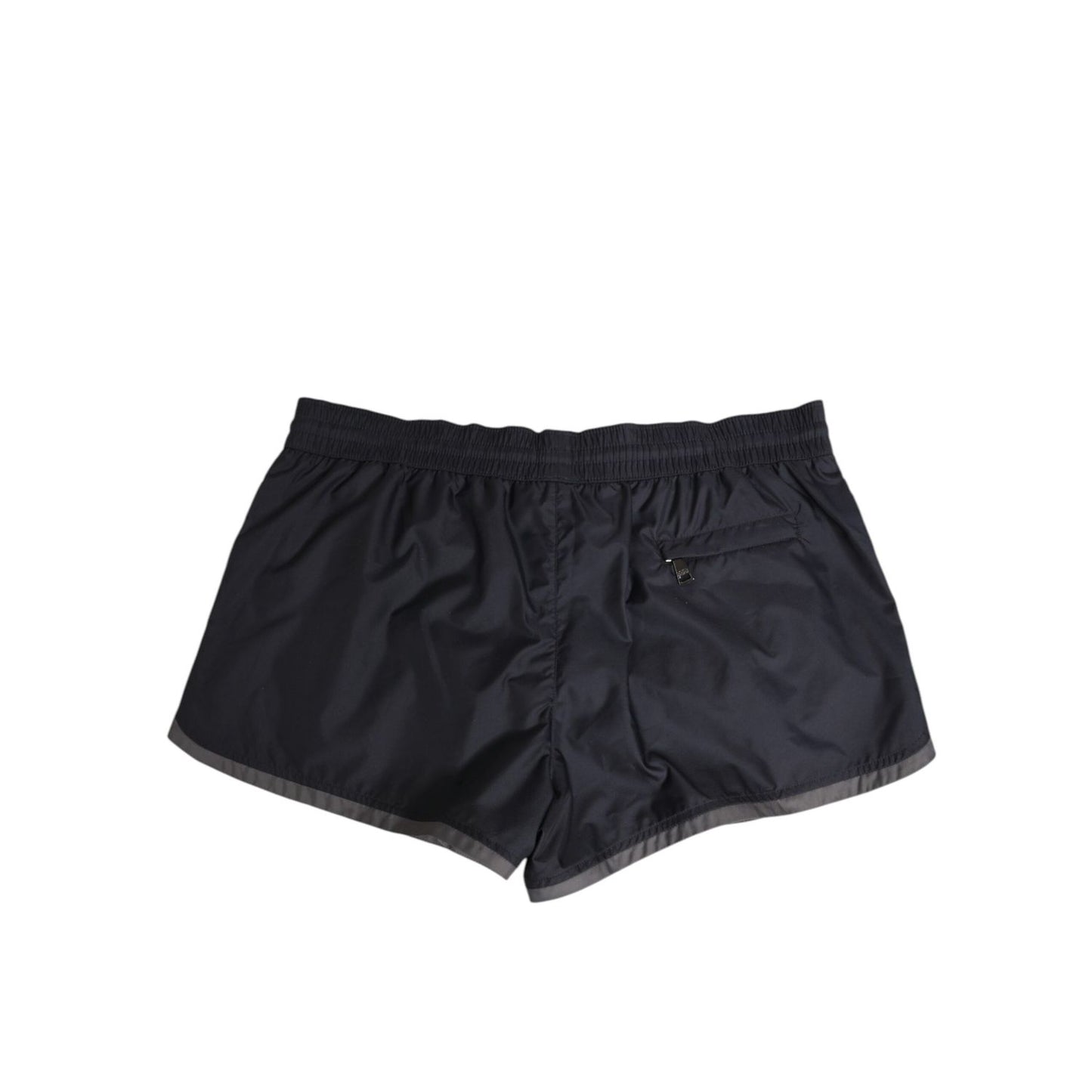 Dolce & Gabbana Black White Polyester Logo Elastic Waistband Swimwear, back view of black swim shorts with white stripes and mesh lining.