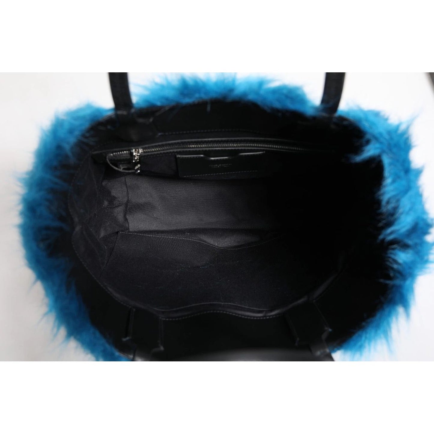 Interior view of Dolce & Gabbana Blue Fur Logo Plaque Double Handle Shoulder Bag with zipper and black lining.