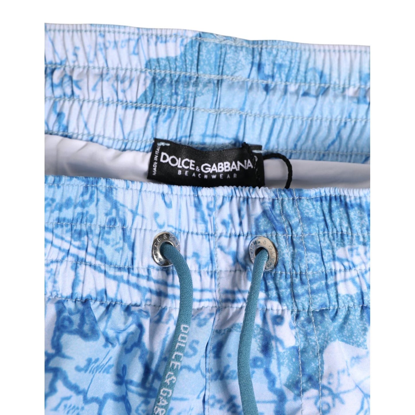 Dolce & Gabbana Blue World Map Polyester Elastic Waistband Swimwear with drawstring and logo details, close-up view.