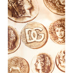 Dolce & Gabbana Brown Ancient Coin Print Silk Shorts Swimwear with logo detail on beige fabric background.
