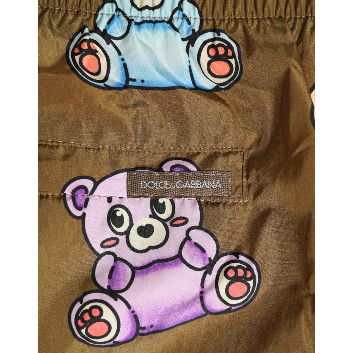 Dolce & Gabbana Brown Multicolor Teddy Bear Men Shorts Swimwear with purple teddy bear print and Dolce & Gabbana logo.