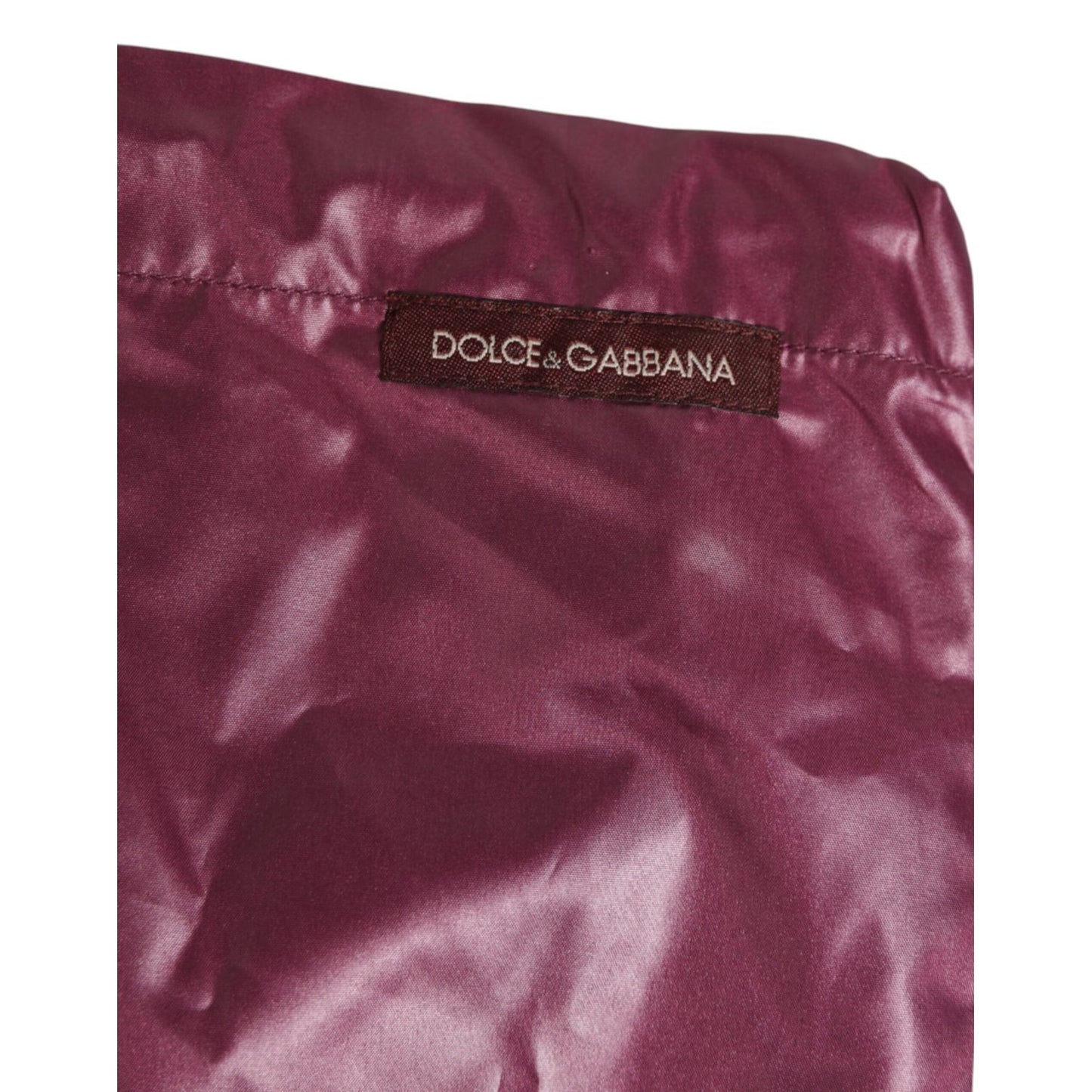 Dolce & Gabbana Burgundy Polyester Logo Embossed Crest Swimwear with glossy finish and DG embroidered crest in Italy, close-up view