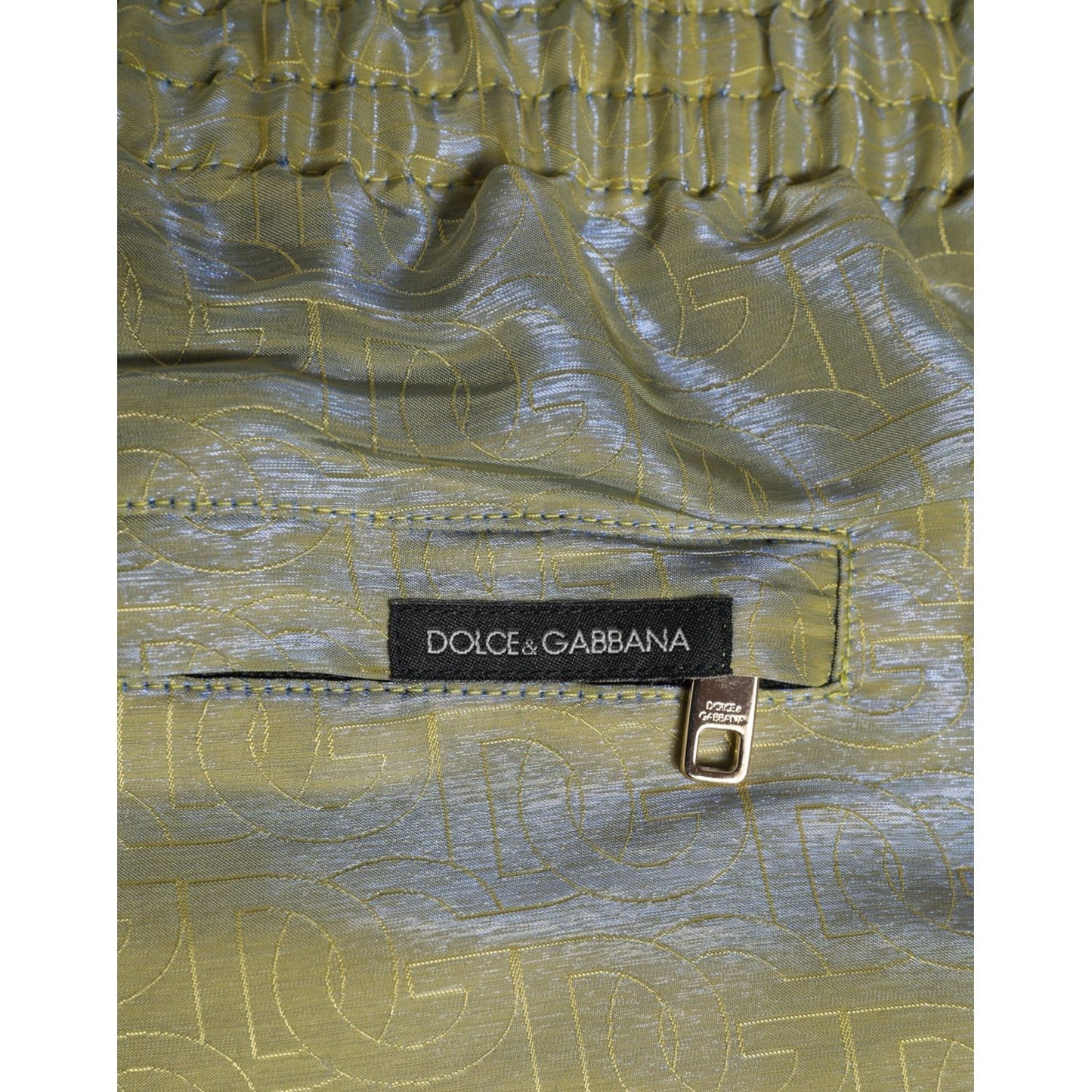 Dolce & Gabbana Green Polyester Metallic Logo Print Men Swimwear close-up with zipper pocket and logo details