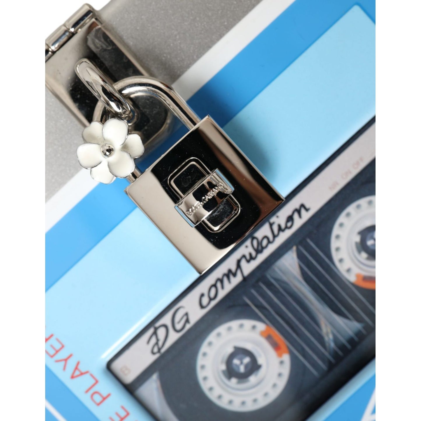 Close-up of Dolce & Gabbana Multicolor Cassette Player Box DG Music Crossbody Shoulder Bag with padlock and flower charm.