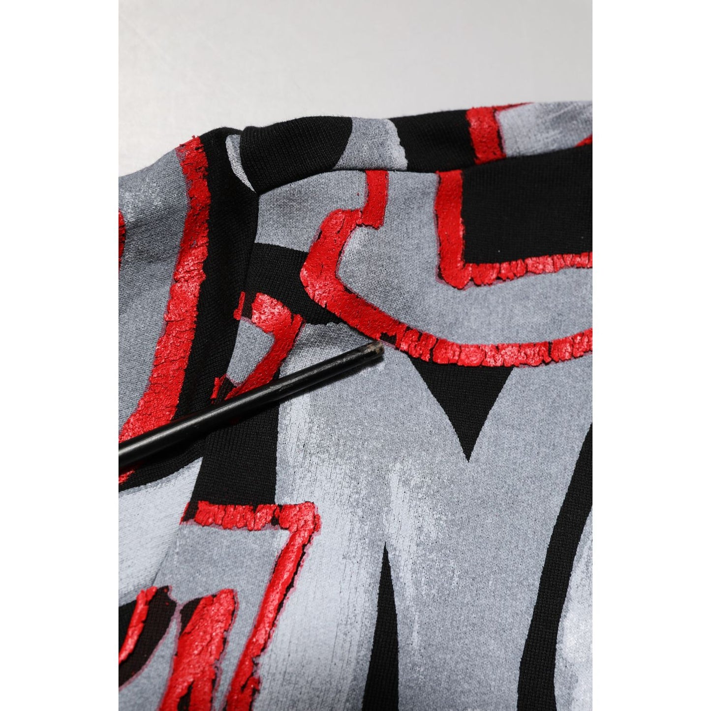 Close-up of Dolce & Gabbana Multicolor Logo Monogram Crew Neck Sweater featuring vibrant red and black DG design.