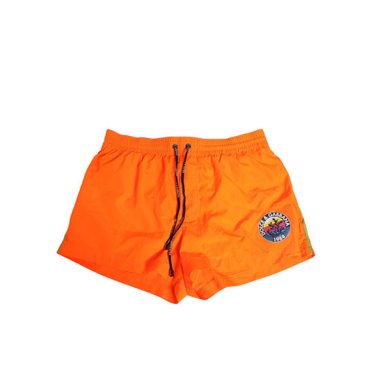 Dolce & Gabbana Orange Polyester Beachwear Men Shorts Swimwear with logo and drawstring waistband.