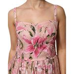 Dolce & Gabbana Pink Cotton Floral Pleated Sleeveless Dress with lily print, fitted bodice, adjustable straps, vibrant pink and green pattern.