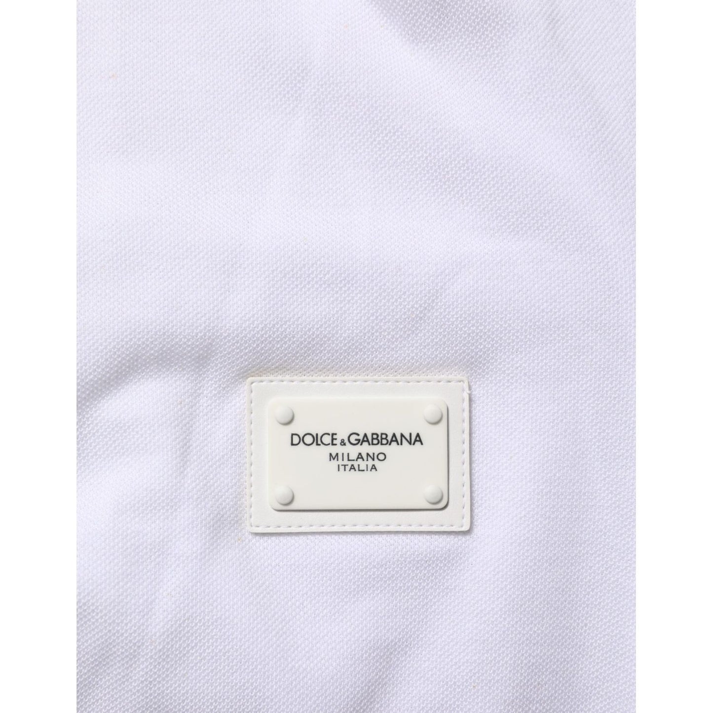 Close-up of label on Dolce & Gabbana White Collared Short Sleeves Polo T-shirt, 100% cotton, shows minor defects, branded fashion.