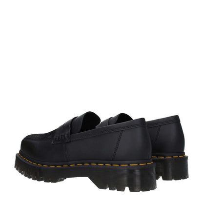 Dr. Martens Black Leather Slip-On Loafers with square toe and mid heels, showcasing durable rubber sole, perfect for casual wear.
