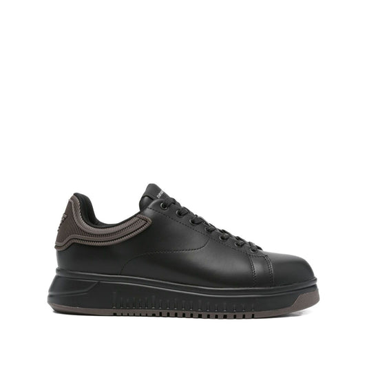 EMPORIO ARMANI EXCLUSIVE Lace-up low-top sneakers, black leather with ribbed panel and flat rubber sole, featuring tonal stitching.