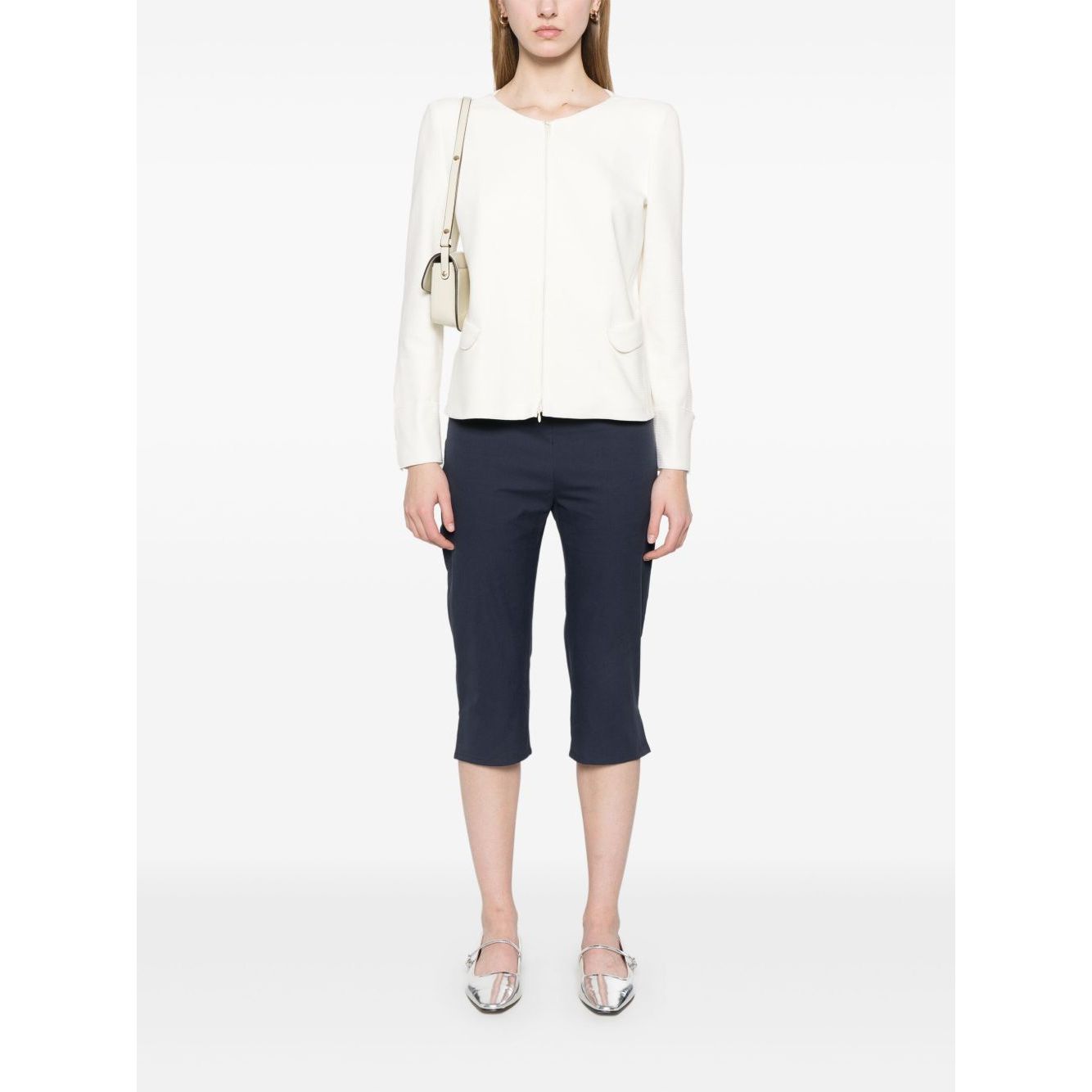 Model wearing Emporio Armani Ottoman-jersey jacket in white with navy pants and silver shoes, featuring a two-way zip fastening and shoulder pads.