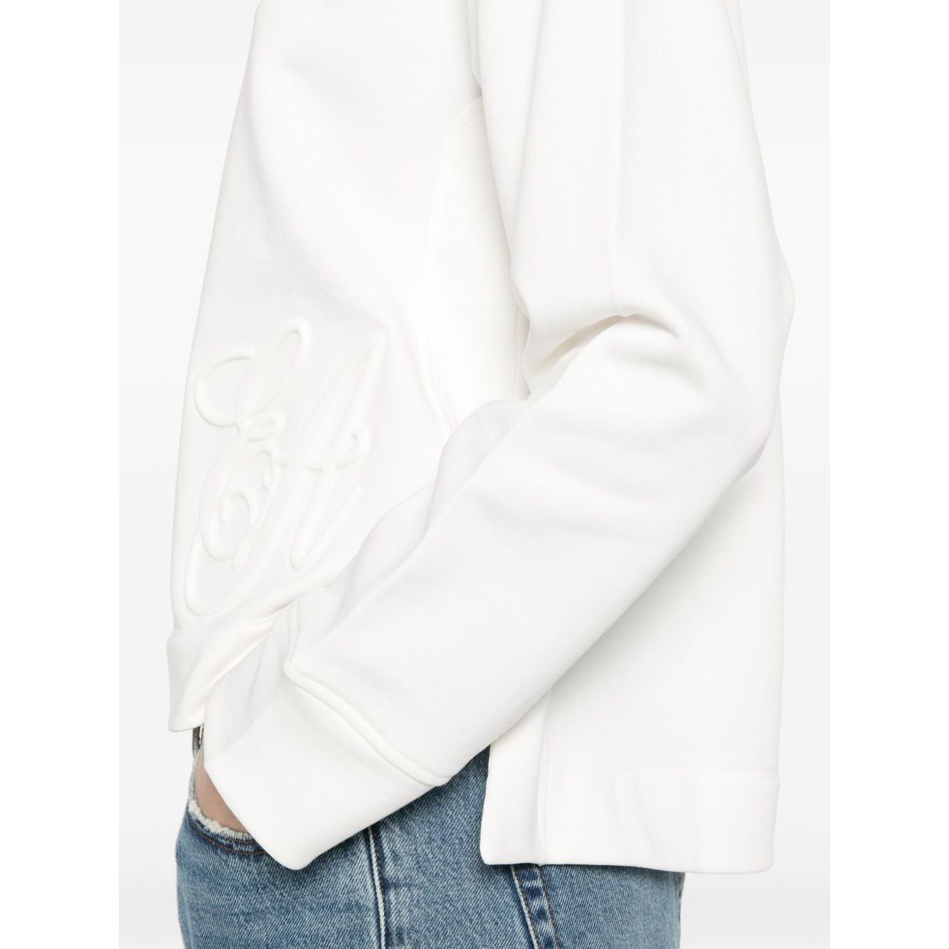 Emporio Armani logo embroidered sweatshirt in white with ribbed cuffs and hem, worn by a model, showcasing organic cotton fabric.