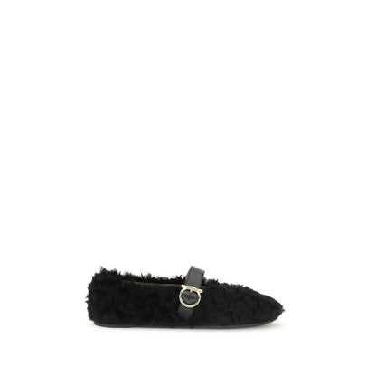 Ferragamo Black Fur Ballet Flats with Gancini buckle embellishment and shearling lining, featuring a contoured neckline and rubber sole.