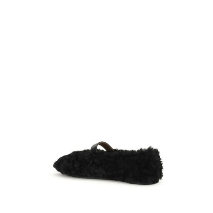 Ferragamo Black Fur Ballet Flats with Gancini embellishment, shearling lining, and rubber sole, showcasing iconic style for AW25.
