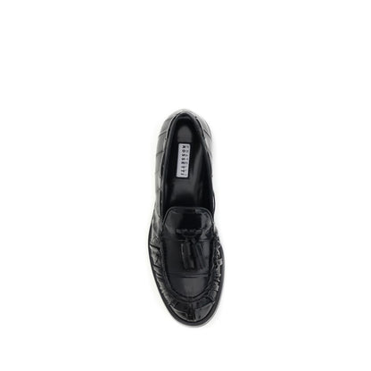 Fratelli Rossetti Black Rubber Slip-On Loafers with tassels, top view, showcasing the elegant design and craftsmanship for versatile styling.