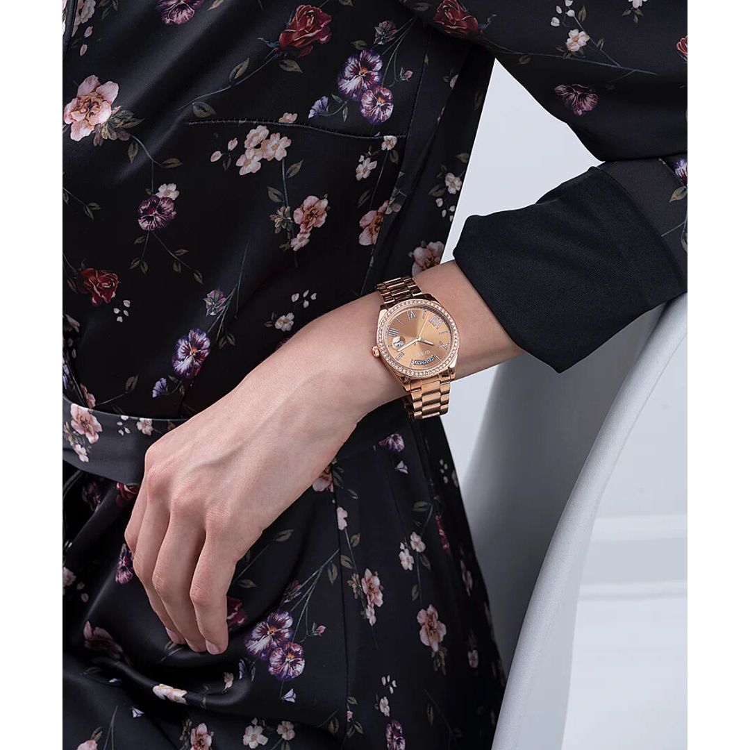 Woman wearing GUESS Mod. GW0307L3 watch, silver 925°, quartz analog, 3 ATM water resistant, 36mm case, floral dress background