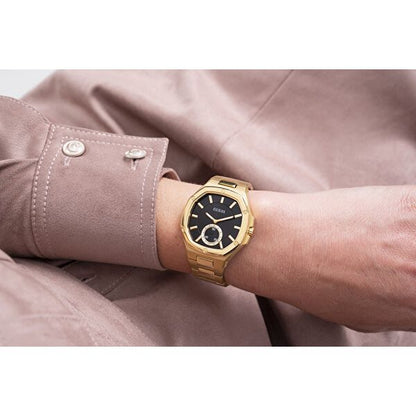 GUESS Mod. GW0310L2 gold watch displayed on wrist with black dial and quartz movement, elegant design for ladies.