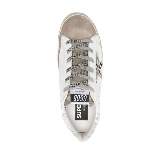 Top view of Golden Goose Super Star low-top sneaker in cloud white leather with star patch, metallic heel counter, logo tongue patch, and rubber sole.