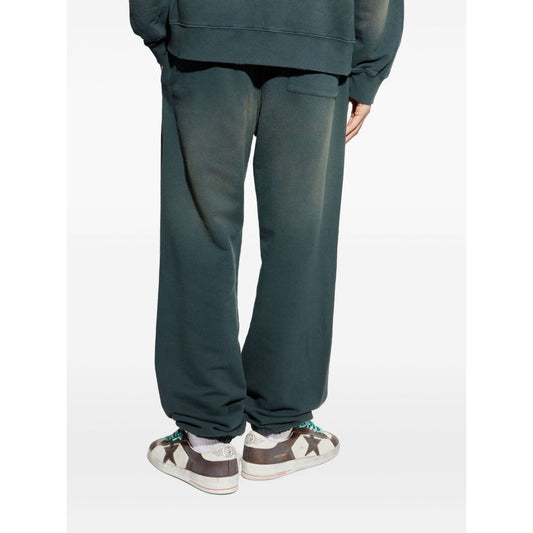 Back view of person wearing Golden Goose Trousers Black with blue waistband and embroidered logo. Casual cotton sweatpants style.