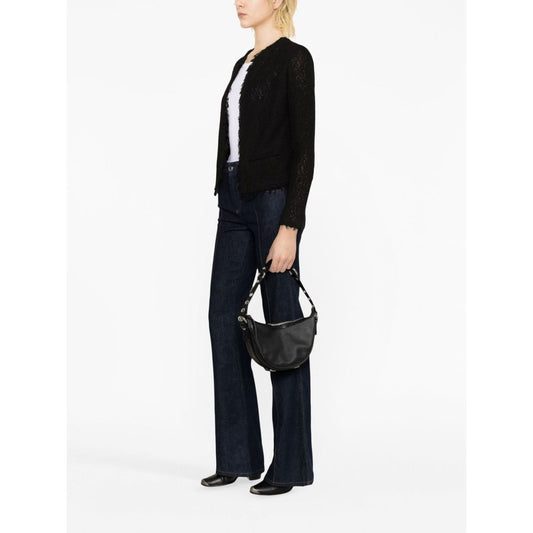 Model wearing Iro Jackets Black with cotton blend, fringe detailing, round neck, and open front, styled with dark denim jeans.