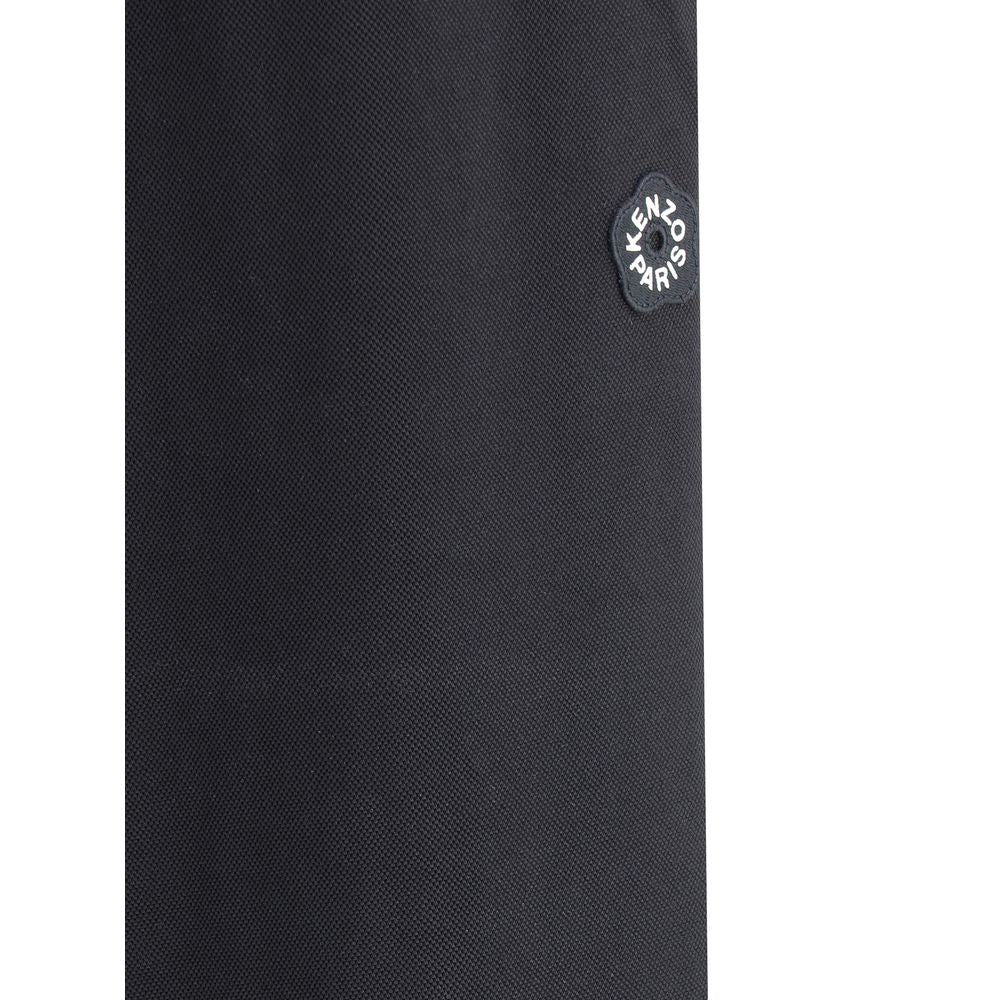 Close-up of Kenzo Black Polyester Joggers (Workout Pants) showing the iconic logo flower on a textured fabric.