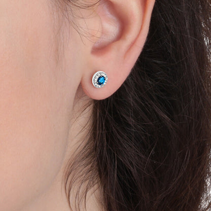 Close-up of an earring from LA PETITE STORY JEWELRY Mod. LPS02ARQ15 featuring a blue stone on a woman's ear.