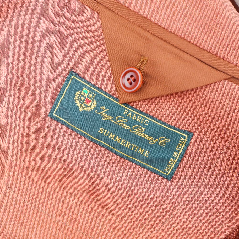 Close-up of the Loro Piana fabric label inside a Made in Italy Brown Linen Blazer, showing rust-colored linen-wool blend texture.
