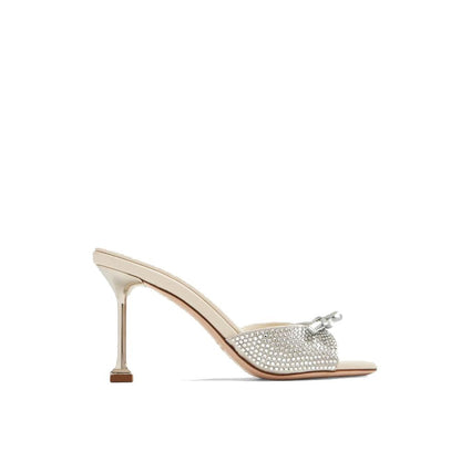 Miu Miu Silver Silk Mules with crystal embellishments and bow detail, featuring a 9 cm heel and open toe design.