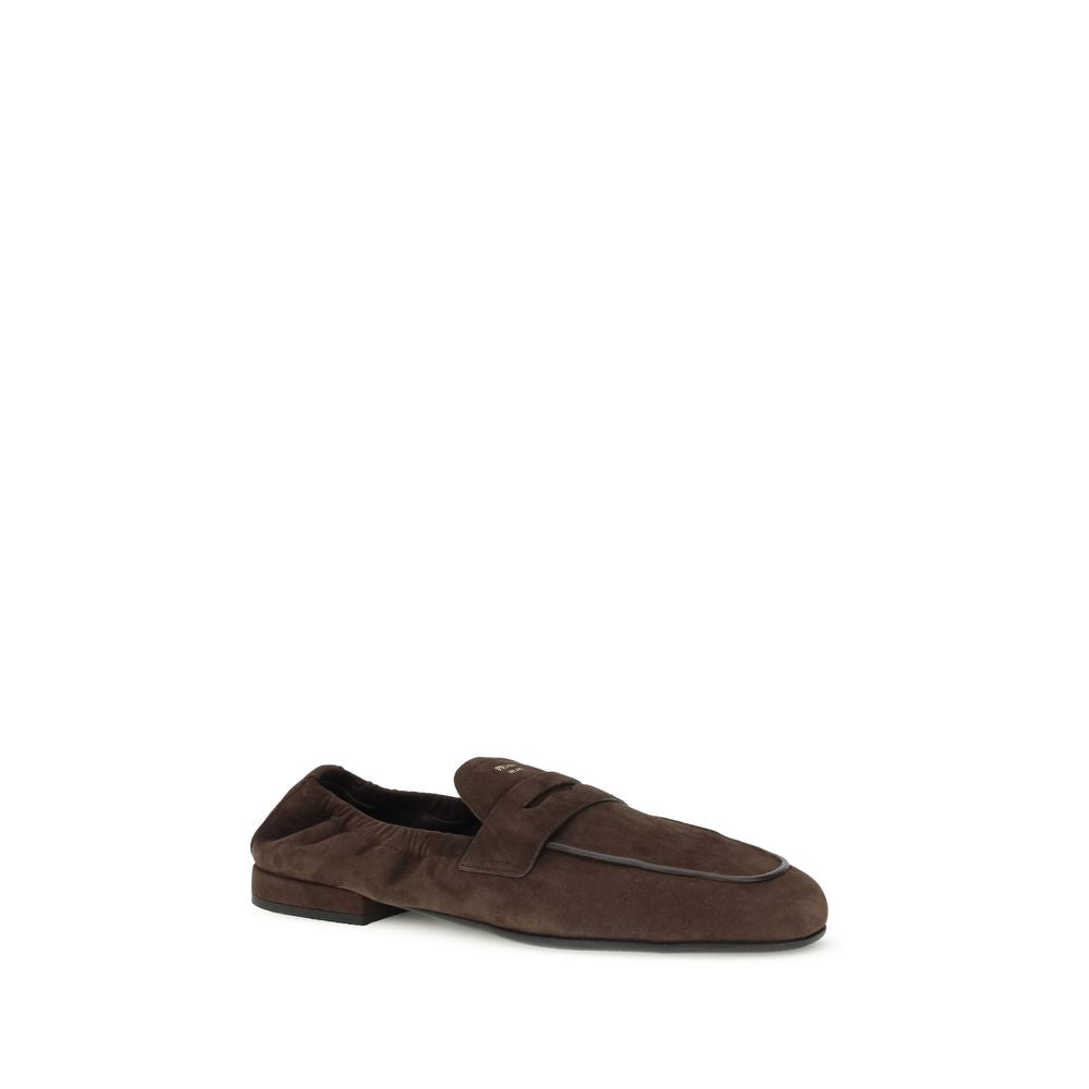 Prada Brown Lamb Ovis Aries Aries Slip-On Loafers with suede finish, leather horsebit upper, screen-printed logo, and rubber sole.